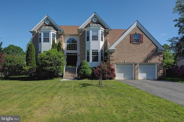 5 Pierce Rd, East Windsor, NJ 08520 - view of front of house featuring asphalt driveway, an attached garage, a front lawn, and brick siding