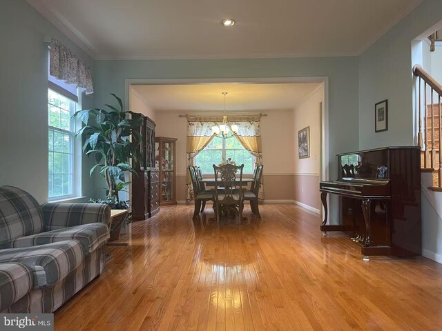 5 Pierce Rd, East Windsor, NJ 08520 - dining area with light wood finished floors, a chandelier, baseboards, stairway, and ornamental molding