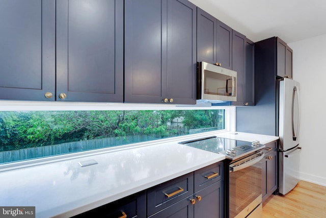 407 Salmon St, Philadelphia, PA 19125 - kitchen with appliances with stainless steel finishes, light countertops, light wood finished floors, and baseboards