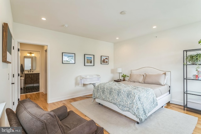407 Salmon St, Philadelphia, PA 19125 - bedroom with light wood finished floors, baseboards, recessed lighting, and connected bathroom