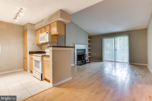 1525 Lincoln Way Unit 301A, Mclean, VA 22102 - kitchen featuring white appliances, dark countertops, light wood-style flooring, light brown cabinetry, and a textured ceiling