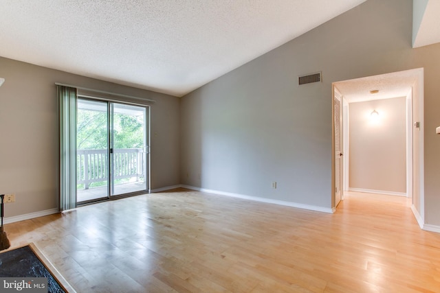 1525 Lincoln Way Unit 301A, Mclean, VA 22102 - unfurnished room featuring light wood-style floors, vaulted ceiling, baseboards, and a textured ceiling