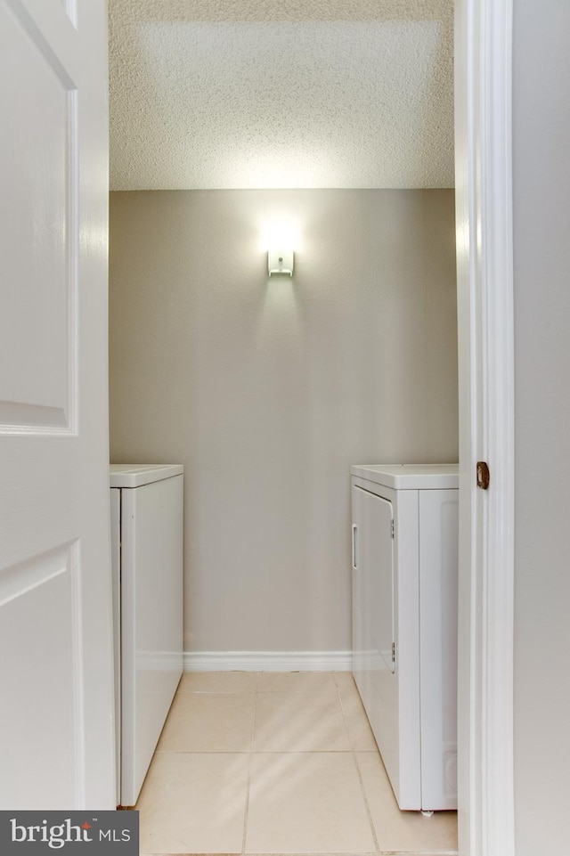 1525 Lincoln Way Unit 301A, Mclean, VA 22102 - laundry room with washing machine and clothes dryer and light tile patterned flooring