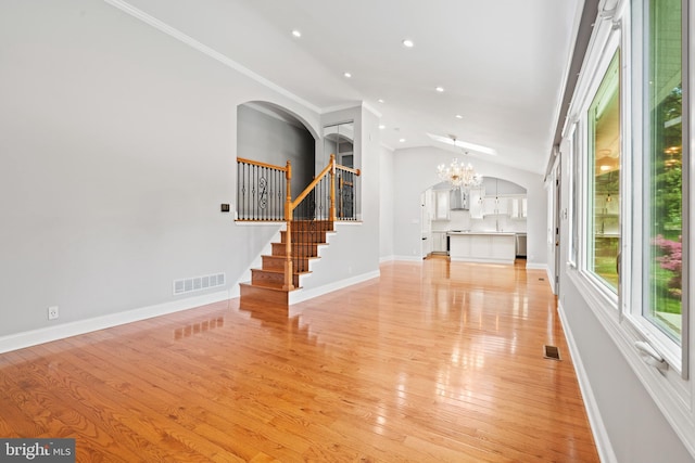 826 Suffolk Rd, Jenkintown, PA 19046 - foyer entrance with arched walkways, light wood-type flooring, vaulted ceiling, recessed lighting, and stairway