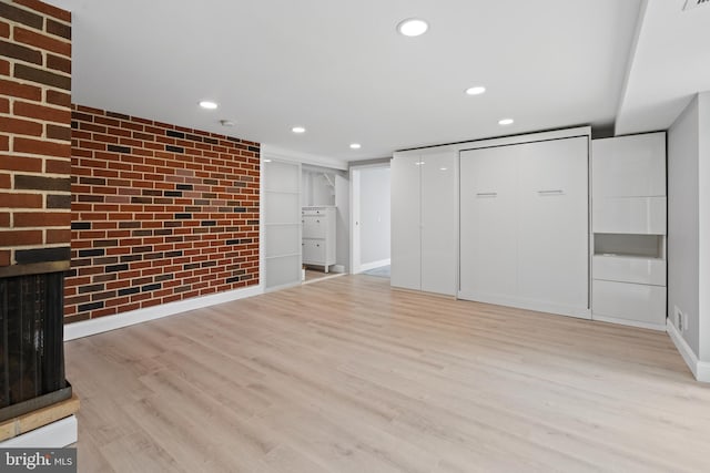 826 Suffolk Rd, Jenkintown, PA 19046 - unfurnished living room featuring light wood-style flooring, recessed lighting, brick wall, baseboards, and a brick fireplace