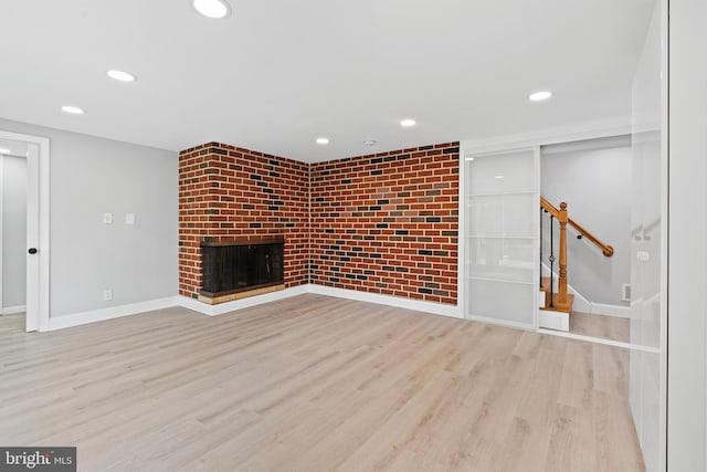 826 Suffolk Rd, Jenkintown, PA 19046 - unfurnished living room featuring stairs, wood finished floors, recessed lighting, baseboards, and a brick fireplace
