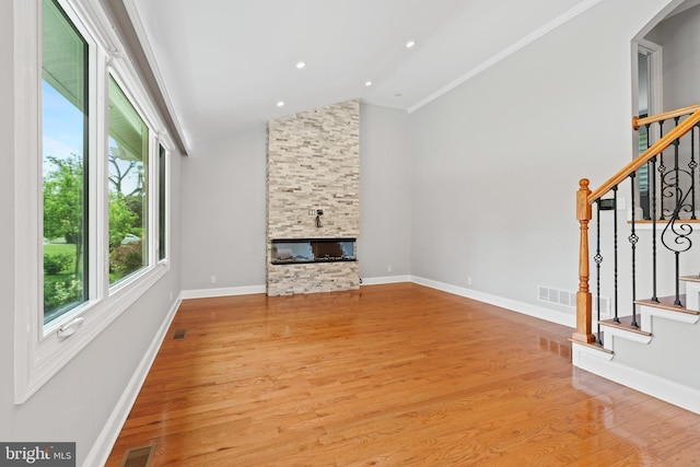 826 Suffolk Rd, Jenkintown, PA 19046 - unfurnished living room with a stone fireplace, stairway, wood finished floors, arched walkways, and high vaulted ceiling