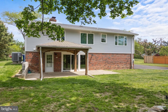 826 Suffolk Rd, Jenkintown, PA 19046 - rear view of house with brick siding, cooling unit, a patio area, a chimney, and a yard