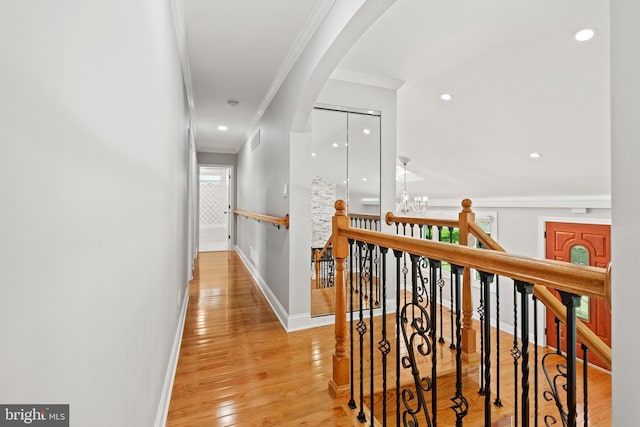826 Suffolk Rd, Jenkintown, PA 19046 - hallway with ornamental molding, an upstairs landing, arched walkways, baseboards, and light wood-style flooring