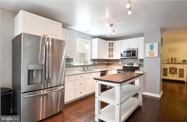 11714 Falcon Ridge Dr, Fredericksburg, VA 22407 - kitchen with appliances with stainless steel finishes, a sink, glass insert cabinets, tasteful backsplash, and white cabinets