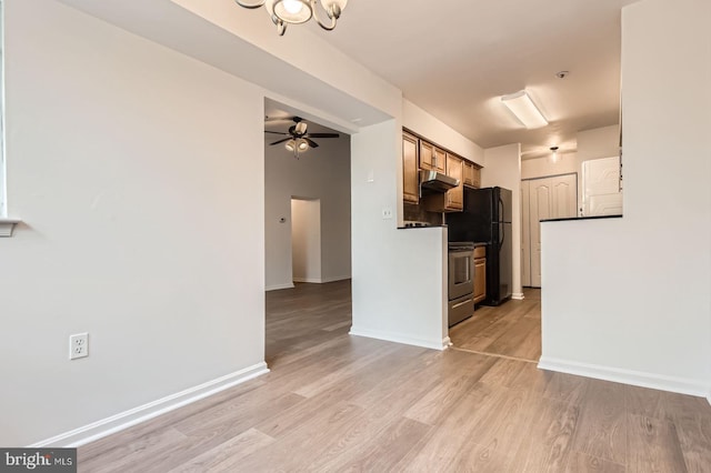 8385 Montgomery Run Rd Unit G, Ellicott City, MD 21043 - kitchen featuring under cabinet range hood, light wood-style floors, ceiling fan, freestanding refrigerator, and a chandelier