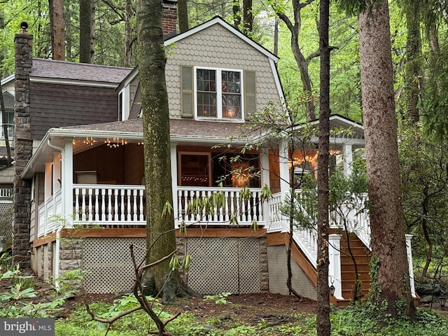 210 Pennsylvania Ave, Mount Gretna, PA 17064 - view of front facade featuring a chimney, covered porch, roof with shingles, and stairs