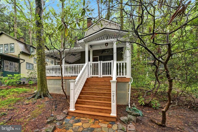210 Pennsylvania Ave, Mount Gretna, PA 17064 - view of front of house with a ceiling fan, a chimney, stairs, and covered porch