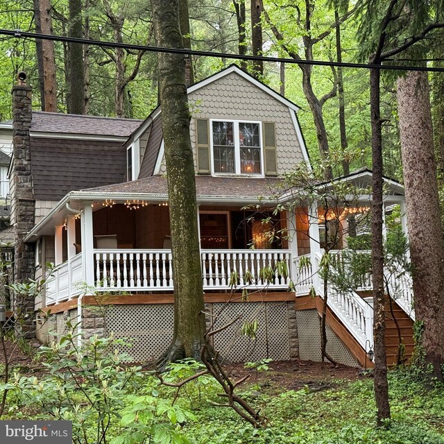210 Pennsylvania Ave, Mount Gretna, PA 17064 - view of front of home featuring covered porch, a shingled roof, and stairway