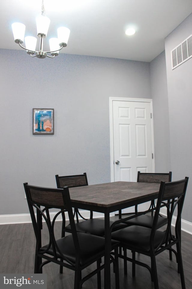 5E 27th St, Baltimore, MD 21218 - dining room with dark wood-type flooring, baseboards, and a chandelier