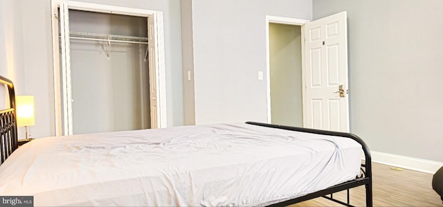 5E 27th St, Baltimore, MD 21218 - bedroom featuring baseboards, a closet, and wood finished floors