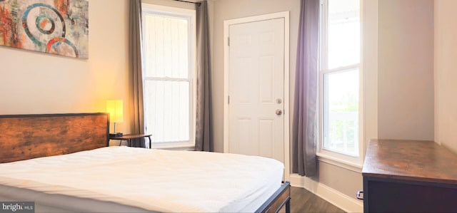 5E 27th St, Baltimore, MD 21218 - bedroom with baseboards and dark wood-type flooring