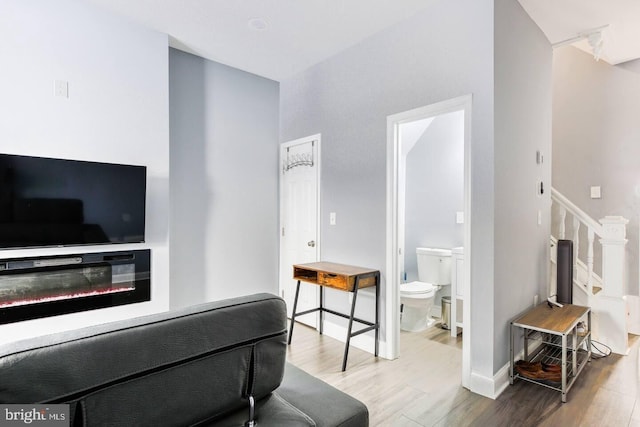 5E 27th St, Baltimore, MD 21218 - living room with wood finished floors, stairway, and baseboards