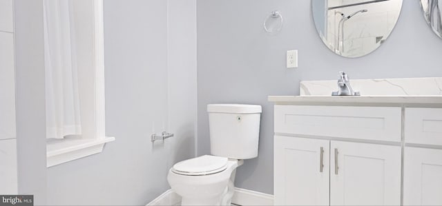 5E 27th St, Baltimore, MD 21218 - bathroom with baseboards, toilet, vanity, and a shower