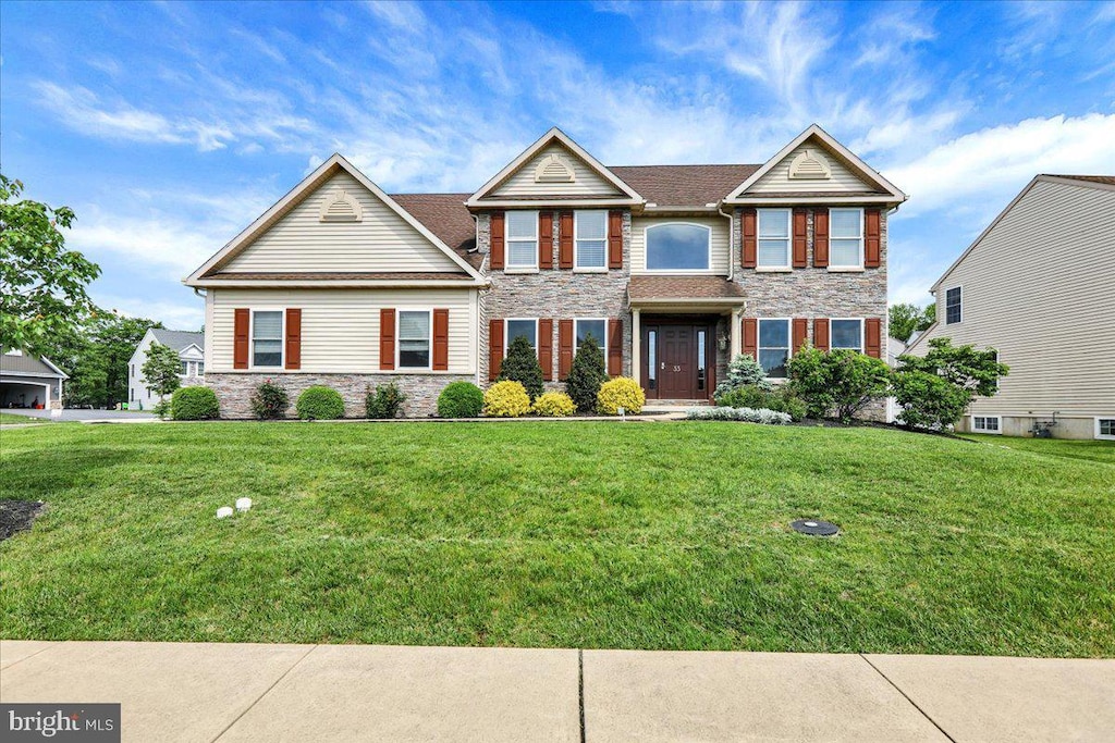 33 Goldeneye Dr, Reading, PA 19608 - view of front of property with stone siding and a front lawn