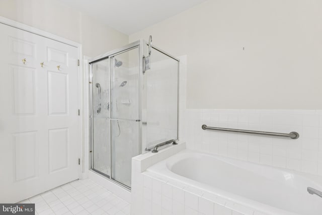 25272 Riffleford Sq Unit 104, Chantilly, VA 20152 - bathroom featuring a bath, a shower stall, and tile patterned flooring