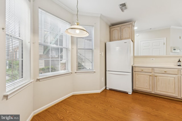 25272 Riffleford Sq Unit 104, Chantilly, VA 20152 - kitchen with freestanding refrigerator, light brown cabinetry, light wood-style floors, ornamental molding, and light countertops
