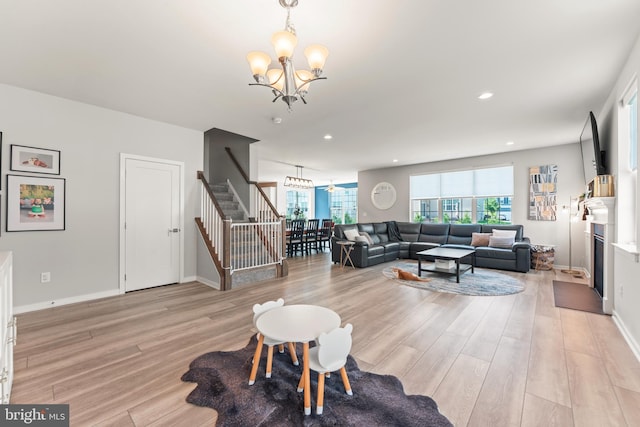2042 Morgan Creek Dr, Quakertown, PA 18951 - living room featuring a chandelier, light wood finished floors, stairway, a fireplace, and recessed lighting