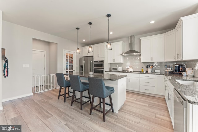 2042 Morgan Creek Dr, Quakertown, PA 18951 - kitchen featuring wall chimney range hood, appliances with stainless steel finishes, a sink, light wood-type flooring, and tasteful backsplash