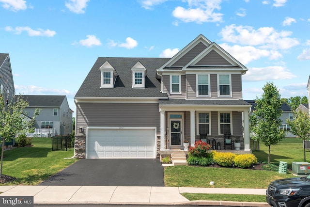2042 Morgan Creek Dr, Quakertown, PA 18951 - view of front facade with a porch, driveway, stone siding, and a front lawn