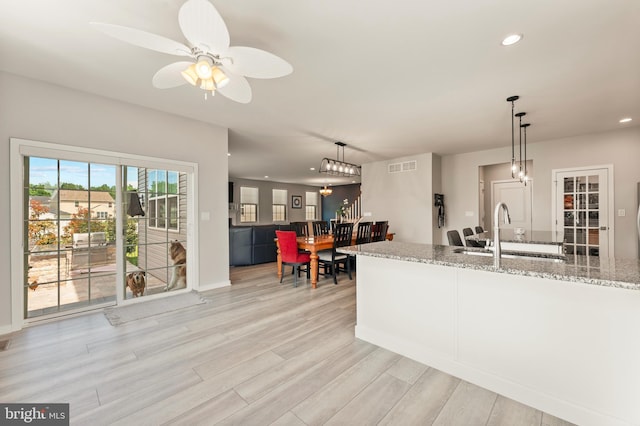 2042 Morgan Creek Dr, Quakertown, PA 18951 - kitchen featuring a sink, recessed lighting, light wood-style floors, light stone counters, and pendant lighting