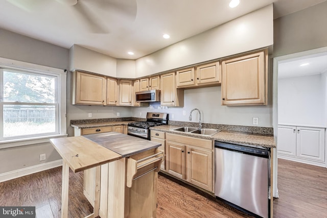 9112 3rd St, Lanham, MD 20706 - kitchen featuring stainless steel appliances, a sink, butcher block countertops, light brown cabinetry, and wood finished floors