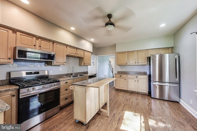 9112 3rd St, Lanham, MD 20706 - kitchen featuring appliances with stainless steel finishes, a sink, a ceiling fan, wood finished floors, and light brown cabinetry