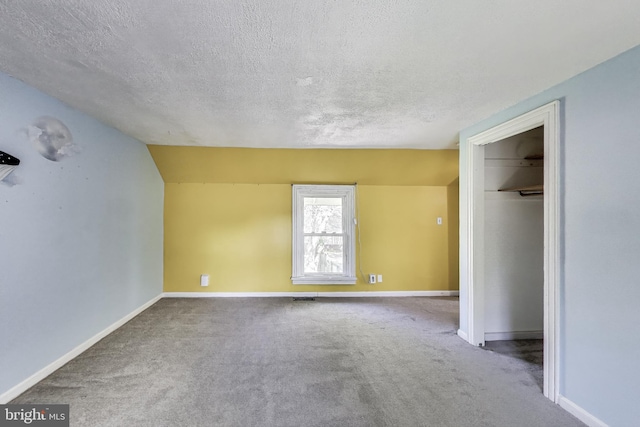 9112 3rd St, Lanham, MD 20706 - unfurnished bedroom with a textured ceiling, carpet floors, baseboards, lofted ceiling, and a closet