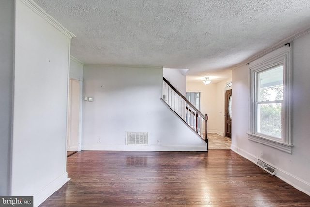 9112 3rd St, Lanham, MD 20706 - unfurnished living room with a textured ceiling, hardwood / wood-style floors, stairs, baseboards, and crown molding