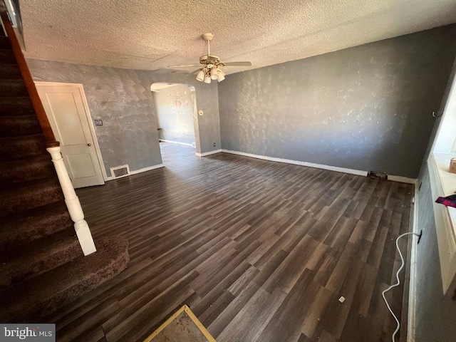 7119 Walker St, Philadelphia, PA 19135 - empty room with arched walkways, a ceiling fan, baseboards, dark wood-style floors, and a textured ceiling