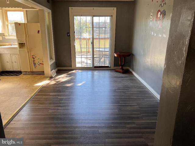 7119 Walker St, Philadelphia, PA 19135 - unfurnished dining area with wood finished floors, a sink, and baseboards