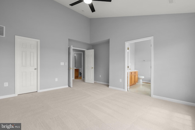 17504 Cajun Ct, Dumfries, VA 22025 - unfurnished bedroom with high vaulted ceiling, light colored carpet, baseboards, connected bathroom, and ceiling fan