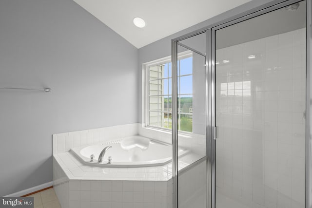 17504 Cajun Ct, Dumfries, VA 22025 - bathroom with a garden tub, vaulted ceiling, a stall shower, tile patterned floors, and baseboards