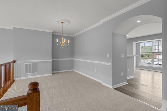 17504 Cajun Ct, Dumfries, VA 22025 - spare room featuring a chandelier, arched walkways, crown molding, and baseboards