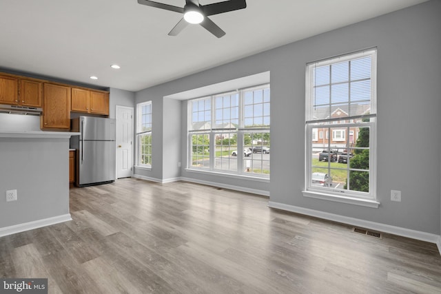 17504 Cajun Ct, Dumfries, VA 22025 - kitchen featuring freestanding refrigerator, brown cabinets, baseboards, wood finished floors, and recessed lighting