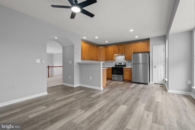 17504 Cajun Ct, Dumfries, VA 22025 - kitchen with appliances with stainless steel finishes, a ceiling fan, light countertops, arched walkways, and recessed lighting