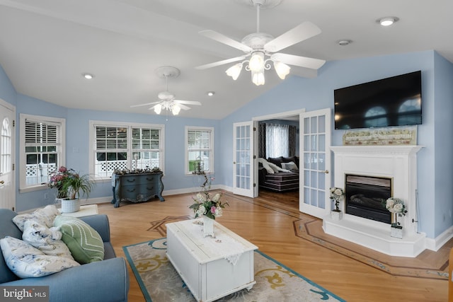 109 Johnson Ave, Oaklyn, NJ 08107 - living area with lofted ceiling, ceiling fan, wood finished floors, a glass covered fireplace, and baseboards