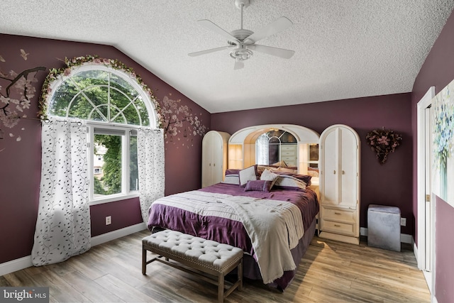 109 Johnson Ave, Oaklyn, NJ 08107 - bedroom featuring vaulted ceiling, multiple windows, wood finished floors, a textured ceiling, and baseboards