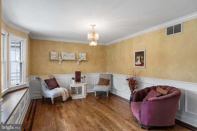 109 Johnson Ave, Oaklyn, NJ 08107 - living area with wood finished floors, a chandelier, crown molding, and a wainscoted wall