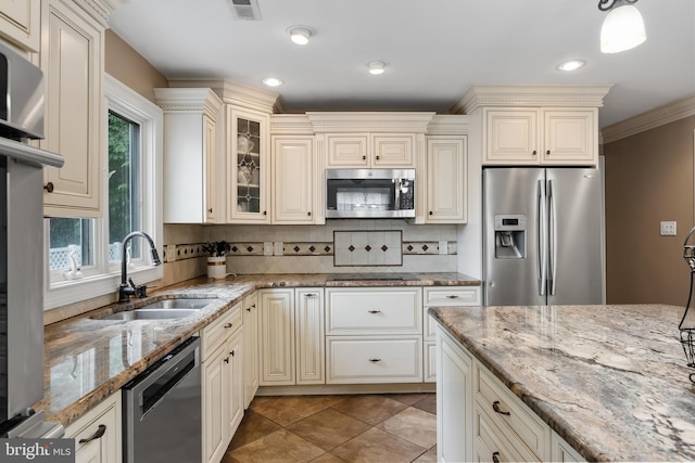109 Johnson Ave, Oaklyn, NJ 08107 - kitchen featuring appliances with stainless steel finishes, a sink, cream cabinets, decorative backsplash, and crown molding