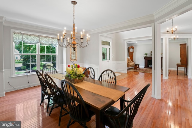 33 Waterview Dr, Pilesgrove, NJ 08098 - dining space with a chandelier, a wainscoted wall, light wood-style floors, crown molding, and a decorative wall