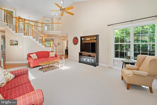 33 Waterview Dr, Pilesgrove, NJ 08098 - carpeted living room featuring stairway, baseboards, ceiling fan, and high vaulted ceiling
