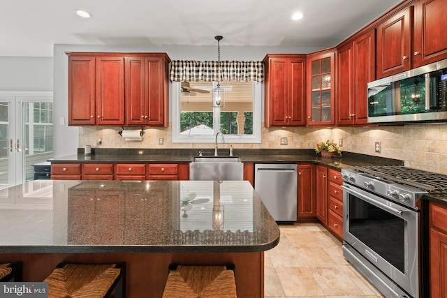 33 Waterview Dr, Pilesgrove, NJ 08098 - kitchen with appliances with stainless steel finishes, a sink, dark brown cabinets, tasteful backsplash, and recessed lighting