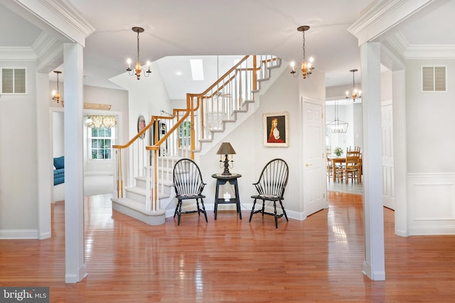 33 Waterview Dr, Pilesgrove, NJ 08098 - foyer entrance with a chandelier, stairway, wood finished floors, and ornamental molding