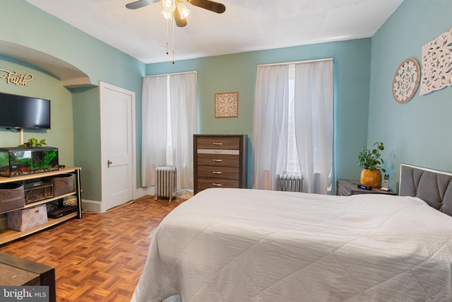 1419 Ellsworth St, Philadelphia, PA 19146 - bedroom featuring radiator heating unit, a ceiling fan, arched walkways, and baseboards